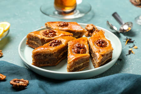 Plate with tasty baklava on blue backgroundの写真素材