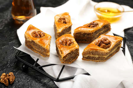 Grid with tasty baklava on dark backgroundの写真素材