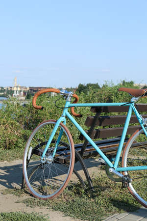 Sporty stylish bicycle in park near benchの写真素材