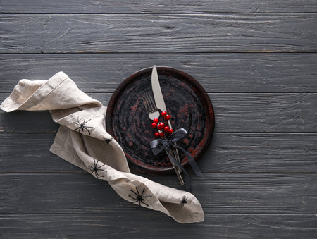 Halloween table setting with spiders on dark wooden backgroundの写真素材