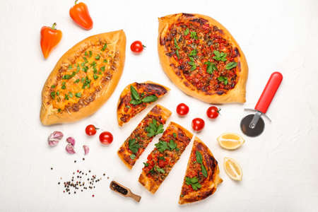 Composition with tasty Turkish Pizza on white background