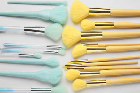 Different stylish makeup brushes on light backgroundの写真素材