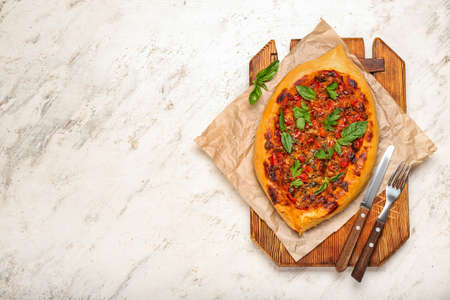 Wooden board with fresh Turkish Pizza on white background