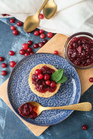 Tasty sandwich with cranberry jam and fresh berries on blue backgroundの写真素材