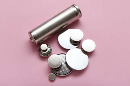 Different batteries on pink backgroundの写真素材