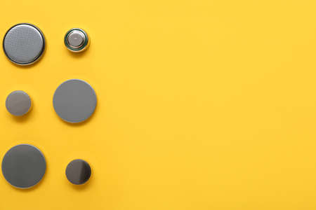 Lithium button cell batteries on yellow background