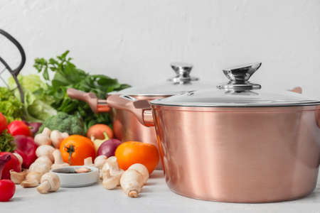 Cooking pot and ingredients for delicious soup on tableの写真素材