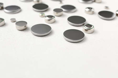 Metal lithium button cell batteries on white background, closeup