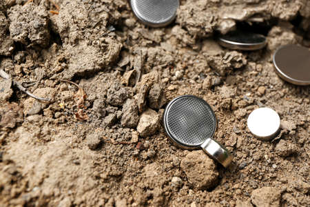 Lithium button cell batteries on soil outdoorsの写真素材