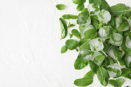 Ice cubes and fresh mint leaves on white backgroundの写真素材