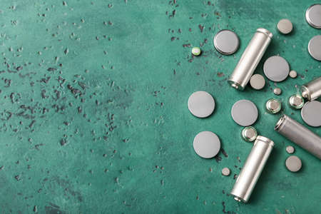 Different metal batteries on green backgroundの写真素材