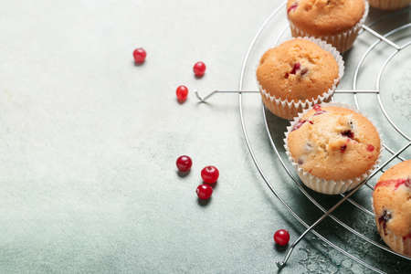 Grid with delicious cranberry muffins on light background, closeupの写真素材