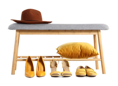 Soft bench with hat, pillow and female shoes on white backgroundの写真素材