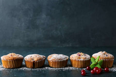 Delicious cranberry muffins on black backgroundの写真素材