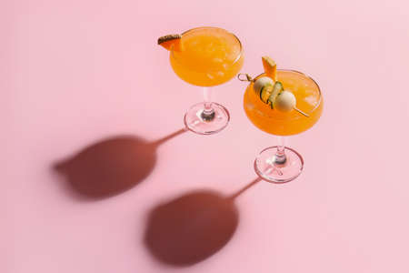 Glasses of melon cocktail on pink backgroundの写真素材