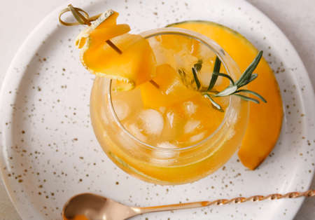 Glass with tasty melon cocktail on table, closeup