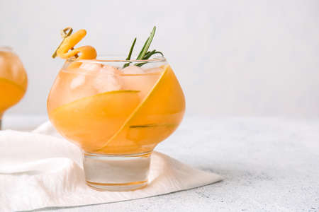 Glass of tasty melon cocktail on light backgroundの写真素材