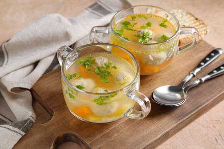 Pots with tasty meatball soup on color background, closeupの写真素材