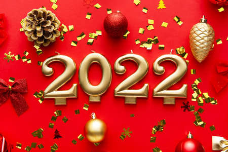 Figure 2022 with decor and confetti on red background