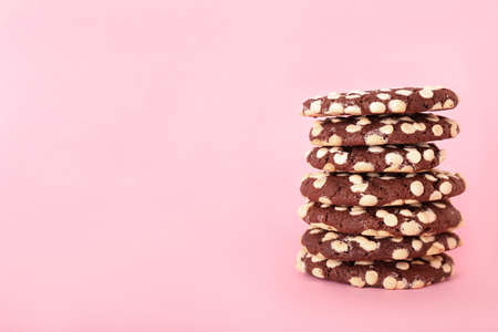 Stack of yummy cookies with white chocolate chips on color backgroundの写真素材