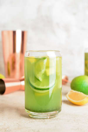 Glass with tasty lemonade on light backgroundの写真素材