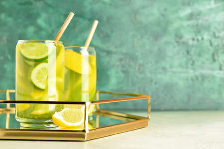 Tray with glasses of tasty lemonade on color backgroundの写真素材