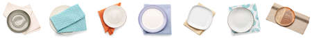 Set of different plates and napkins on white background