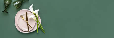 Beautiful table setting with calla lilies on green background. Banner designの写真素材
