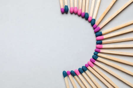 Different new matchsticks on gray background
