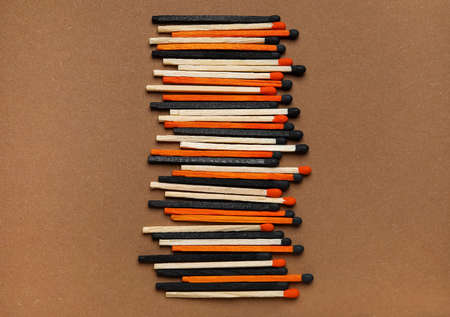 Different new matchsticks on brown background