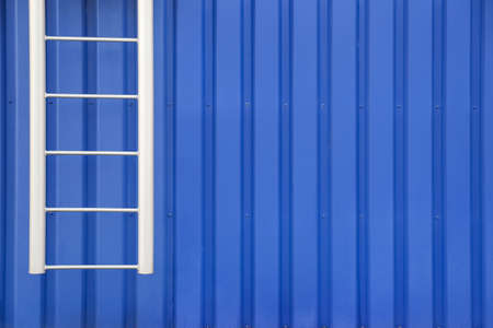 Fire escape metal ladder of blue building outdoors