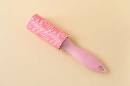 New lint roller on beige background