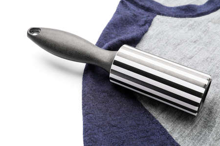 New lint roller with clothes on white background, closeupの写真素材