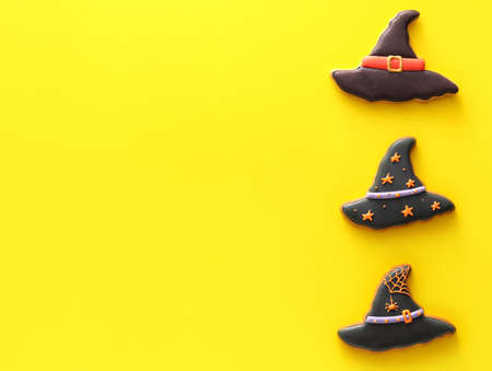 Tasty cookies for Halloween celebration on color background