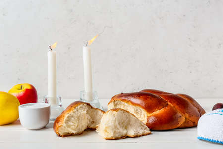 Traditional challah bread with glowing candles on light background. Shabbat Shalomの写真素材