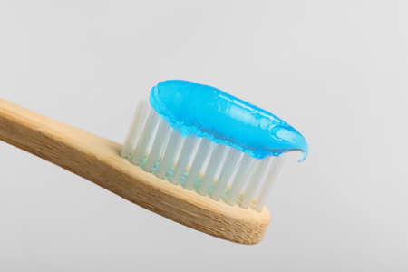 Tooth brush with paste on white background, closeup