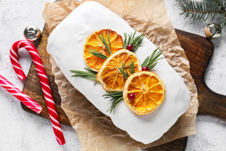 Board with tasty Christmas stollen on light backgroundの写真素材