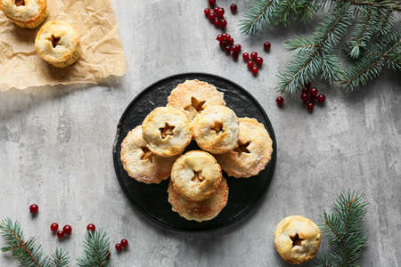Plate with tasty mince pies on gray backgroundの写真素材