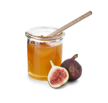 Glass jar with honey and ripe figs on white backgroundの写真素材