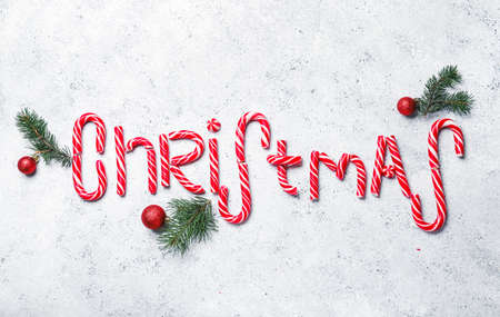Word CHRISTMAS made of candy canes on light backgroundの写真素材