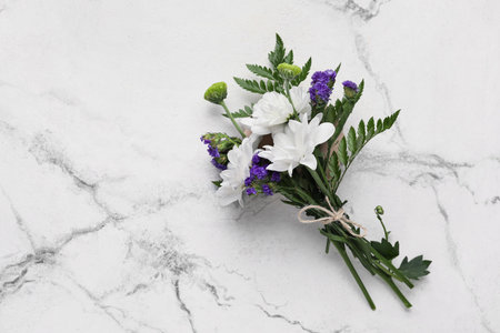 Bouquet of beautiful flowers on light marble background