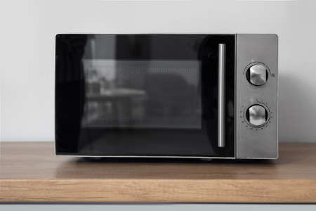 Modern microwave oven on counter in kitchenの写真素材