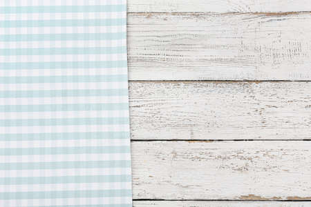 New checkered tablecloth for picnic on white wooden background