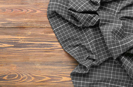 New checkered tablecloth for picnic on wooden wooden background