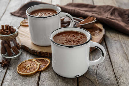 Cups of tasty hot chocolate on wooden backgroundの写真素材