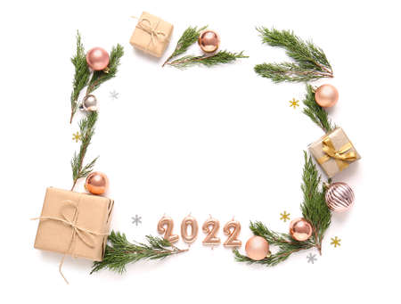 Frame made of coniferous branches, Christmas decorations and gift boxes isolated on white background
