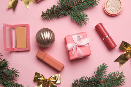Composition with makeup cosmetics and fir branches on color backgroundの写真素材