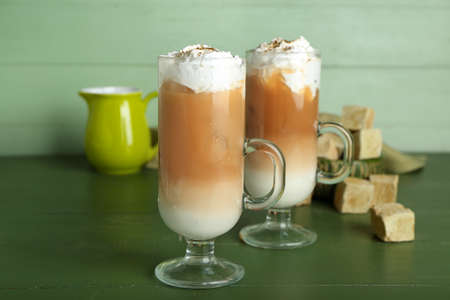 Glass cups of iced hojicha latte on table