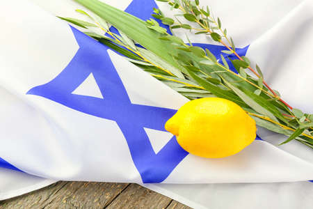 Sukkot festival symbols and flag of Israel on wooden backgroundの写真素材