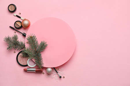 Composition with makeup cosmetics and fir branches on pink backgroundの写真素材